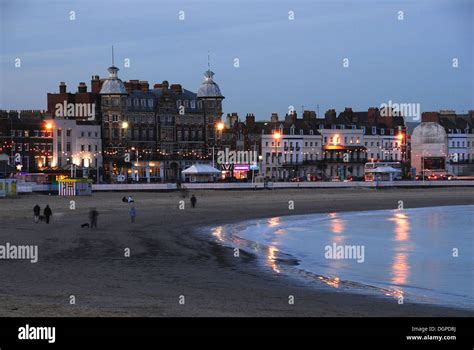 A view of Weymouth seafront Dorset at dusk with people still on the ...