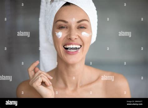 Closeup Portrait Cheerful Woman Laughing Apply On Cheeks Cream Stock