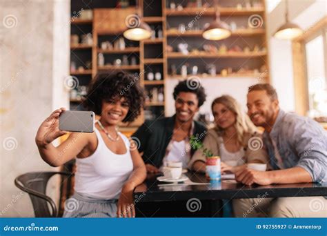 Multiracial Friends Taking Selfie On Smart Phone At Cafe Stock Image