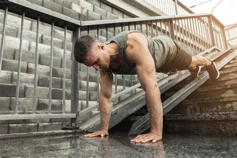 Muscular Man Is Doing Push Ups During Calisthenic Workout On A Street