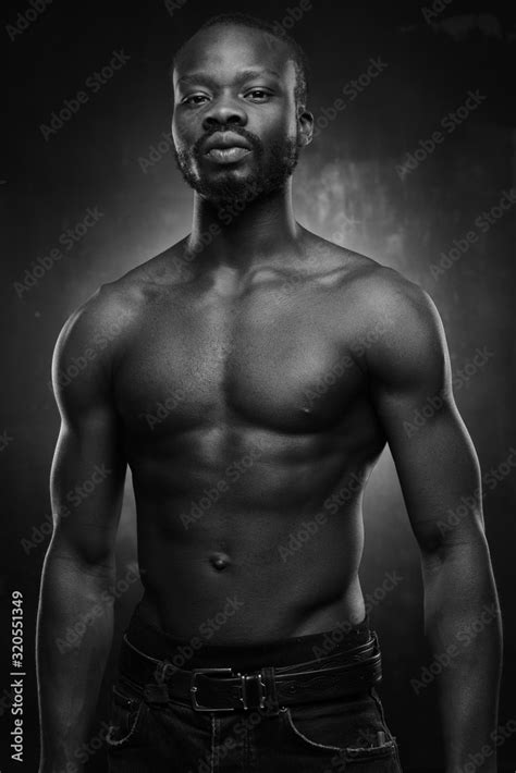 Black And White Portrait Of A Handsome Black Man With Naked Sports Torso Looking In The Camera