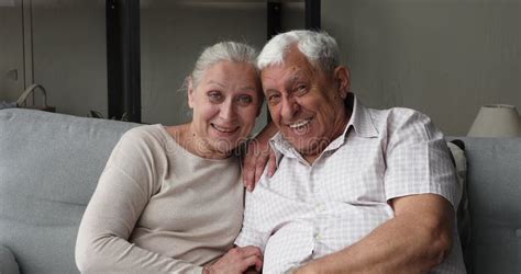 Happy Older Grandma Hug Cuddle Cute Granddaughter Look At Camera Stock