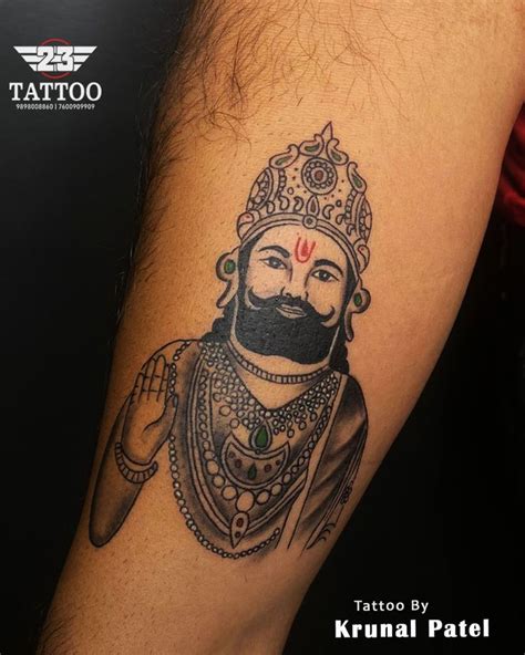 A Man With A Beard Wearing A Crown Tattoo On His Arm