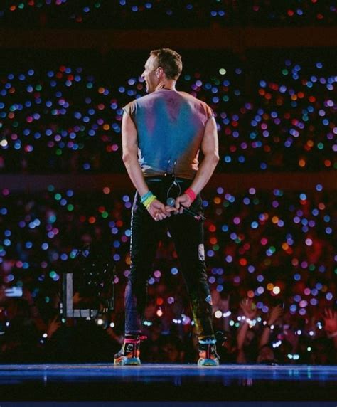 A Man Standing On Top Of A Stage Wearing Roller Blades