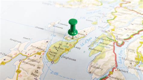 A Green Pin Stuck In A Map Of The Island Of Jura Scotland Stock Photo
