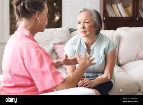 Diverse Senior Female Friends Having Serious Conversation About