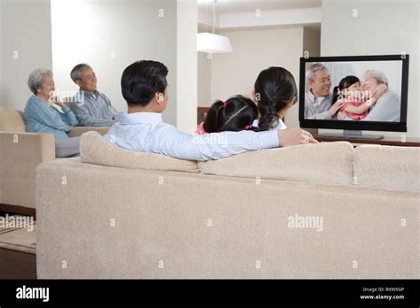 Family watching TV together Stock Photo - Alamy