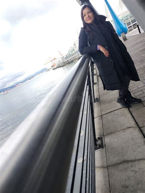 A Year Old Latina Woman Enjoys The View Of The Sea At The Port In