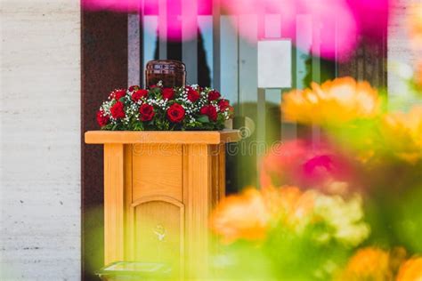 Funerary Urn With Ashes Of Dead And Flowers At Funeral Stock Photo