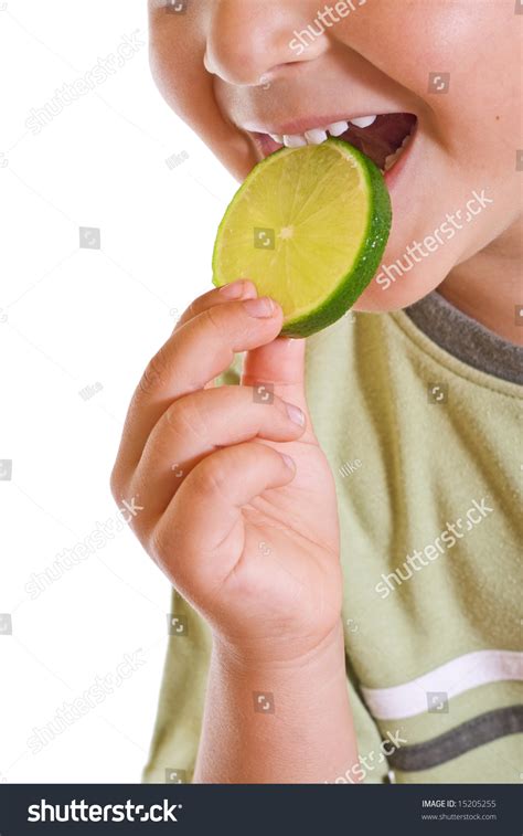 Closeup Of Kid Eating A Slice Of Lime Isolated Stock Photo 15205255