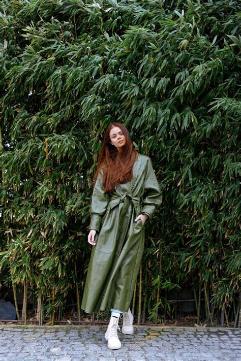 Woman Influencer In Stylish Trendy Clothes Poses Full Length Against A