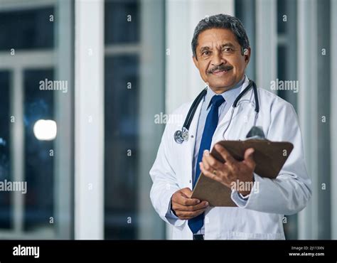 The Doctor Is In Portrait Of A Happy Mature Doctor Holding A Clipboard