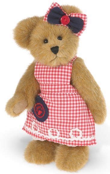 A Brown Teddy Bear Wearing A Red And White Checkered Dress