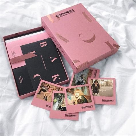 the pink box is full of photos and has been opened to reveal it's contents