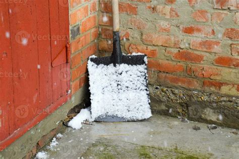 A snow shovel in the snow and stands in the corner 36126490 Stock Photo ...