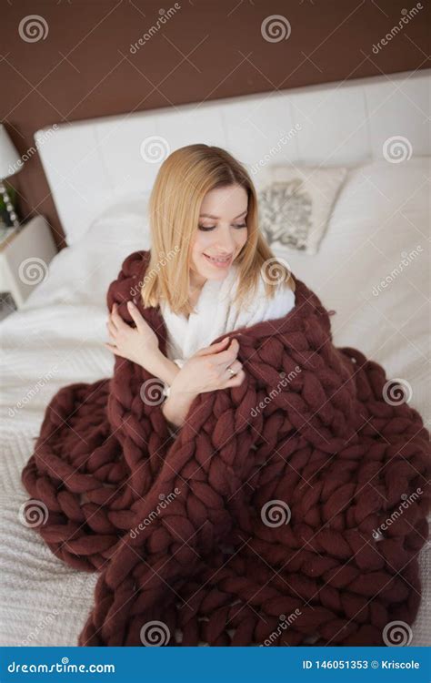 An Attractive Young Woman Is Wrapped In A Soft Fluffy Blanket Stock