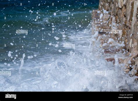 A Closeup Of Waves Splashing On The Rocky Cliff In Zadar Dalmatia