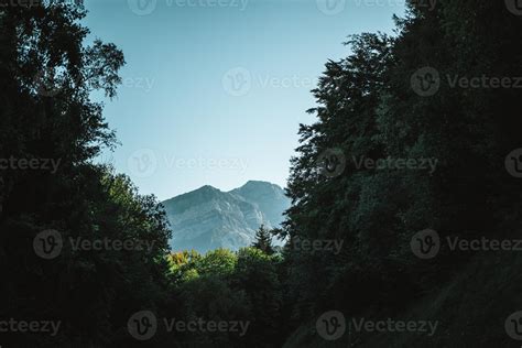 Majestic mountains in the Alps covered with trees and clouds 20497438 ...