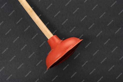 Premium Photo Toilet Plunger On Black Background Red Rubber Cup