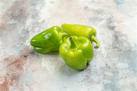 Free Photo Front View Green Peppers On Nude Background With Free Space
