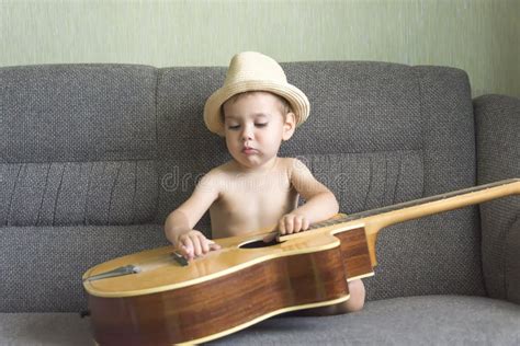 Child playing the guitar stock photo. Image of learning - 122183160