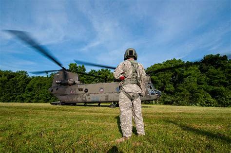 An Army Flight Crew Chief Waits By A Ch Chinook Nara Dvids