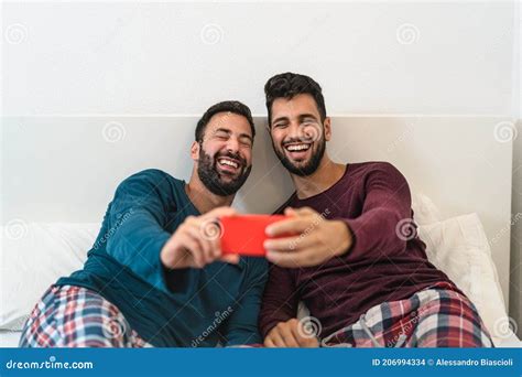 Happy Gay Couple Having Fun Using Mobile Smartphone In Bed Stock Photo Image Of Cell Bonding