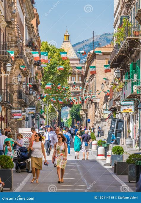 People Walking In Via Vittorio Emanuele In Palermo With Porta Nuova In