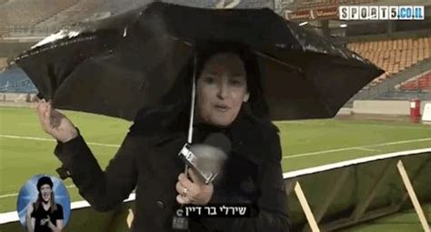 12 People Struggling Comically With Umbrellas In The Wind