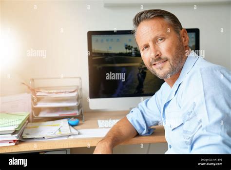 Cheerful Mature Man Sitting In Home Office Stock Photo Alamy