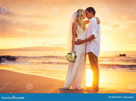 Bride And Groom Kissing Sunset