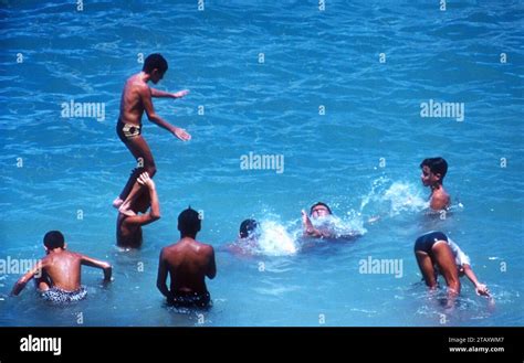 LAKELAND, FL - AUGUST, 1955: A group of kids swim before watching the National Water Skiing ...