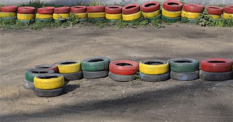 Fencing Of Tires Painted With Paint Of Different Colors Stock Photo