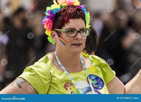 A Woman With Rainbow Flowers In Hair Attending The Gay Pride Parade