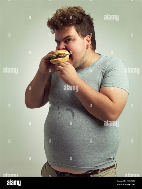 Obesity Weight Gain And Hamburger For Man In Studio With Food For