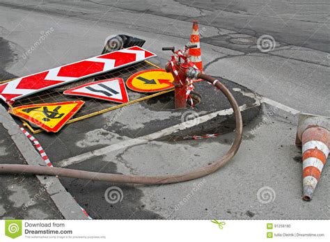 Road Signs Traffic Cones And Red Fire Hydrant With Hose Stock Photo