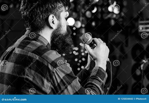 Musician With Beard Singing Song In Karaoke Rear View Man In Checkered Shirt Holds Microphone