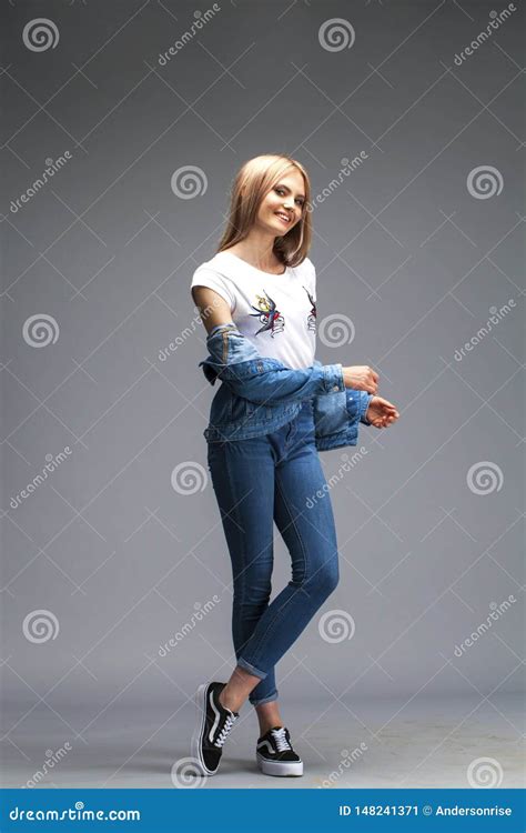 Beautiful Blonde Woman Dressed In A Denim Jacket And Blue Jeans Stock Image Image Of Neat