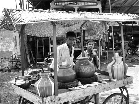 A young man selling pearl millet (bajra) porridge and buttermilk in ...