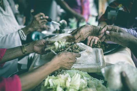 The Concept Of Humanitarian Assistance Sharing Food To The Poor Stock