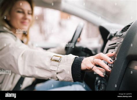 A Woman Amateur Driver Is Playing The Radio In The Car Before Start Driving Traveling With