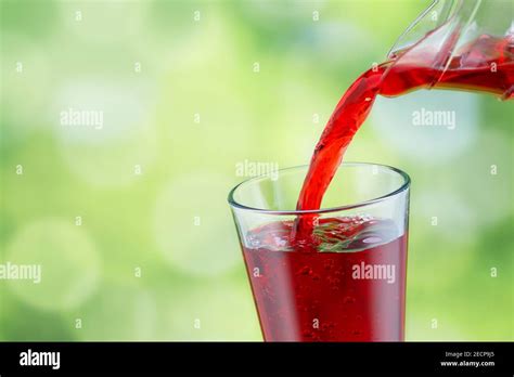 Juice Pouring Into Glass Stock Photo Alamy