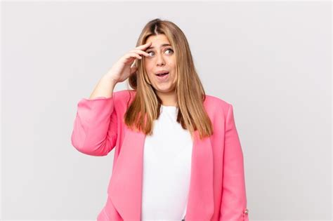 Premium Photo Curvy Pretty Blonde Woman Looking Happy Astonished And Surprised