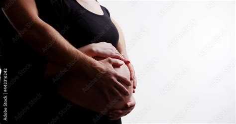 Mom And Dad Hands On Pregnant Tummy Isolated On White Background