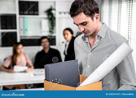 Sad Employee Packing His Belongings After Being Fired For Not Being