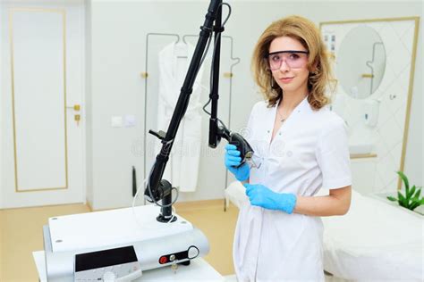 Cosmetologist With Glasses Holds A Co Fractional Ablative Laser For