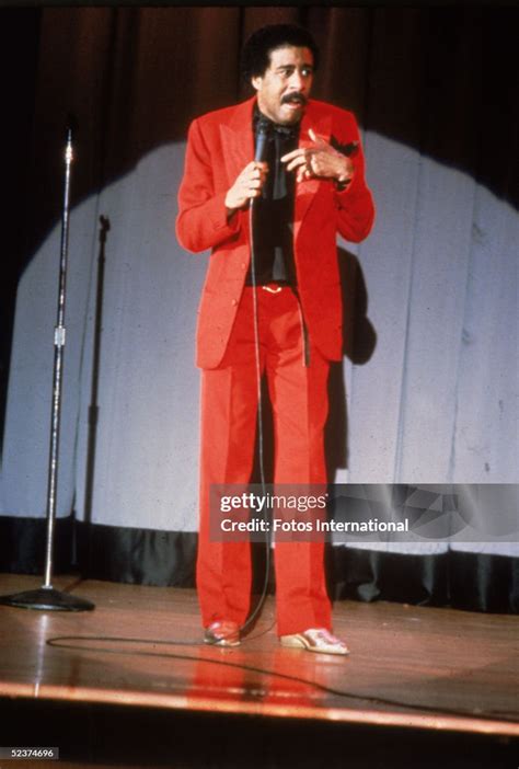 American Comedian Richard Pryor Wears A Bright Red Suit As He News