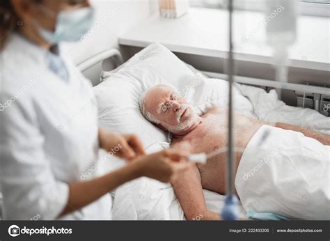 Old Man Sleeping While Doctor Checking Intravenous Drip Stock Photo By