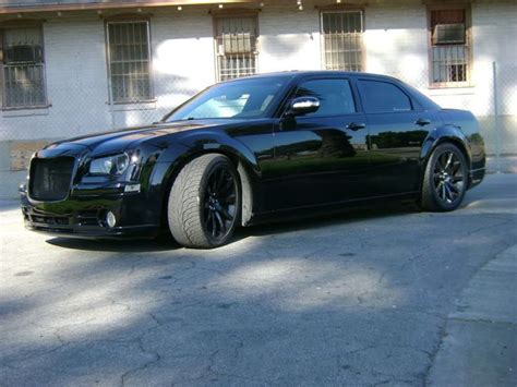 A Black Car Parked In Front Of A Building