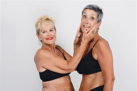 Premium Photo Mature Adult Mother Posing Giving Love To Her Daughter In Underwear Studio Shot